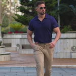 Stylish man wearing avy buttonless polo shirt and brown stretch formal pants outfit