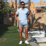 stylish summer outfit with Light blue slim fit polo with very short length chino shorts in light gray