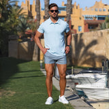 stylish summer outfit with Light blue slim fit polo with very short length chino shorts in light gray