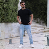 Mean wearing stylish fitted black t-shirt and light blue slim fit jeans by Kojo Fit Australia